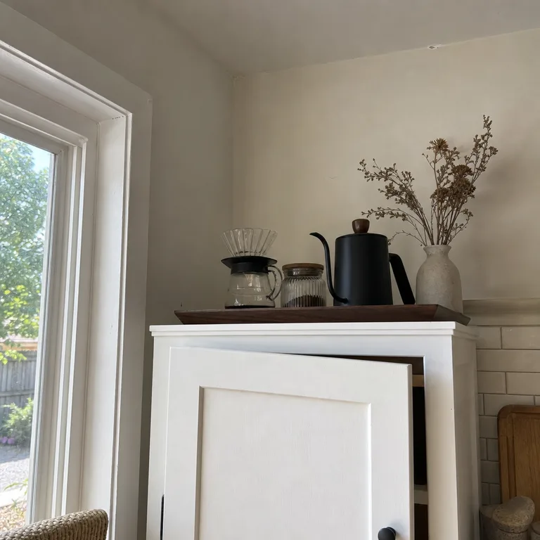A pour-over coffee tray placed on top of a white freestanding pantry cabinet.
