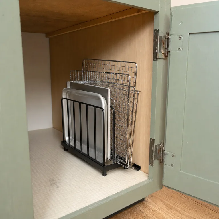 Metal file sorter used to store small baking sheets and cooling racks vertically.