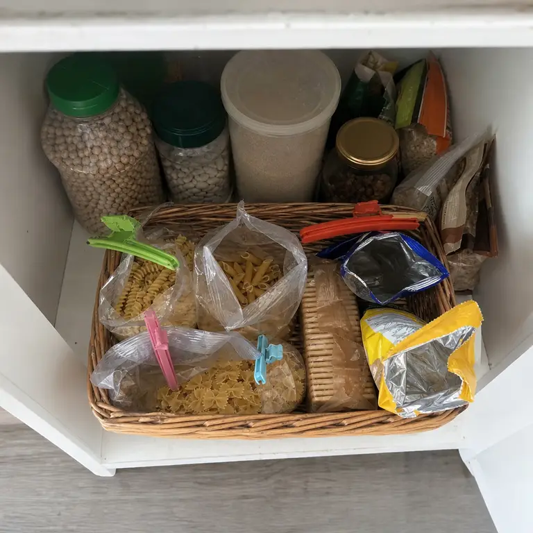 A use-first basket holds opened pantry packages.