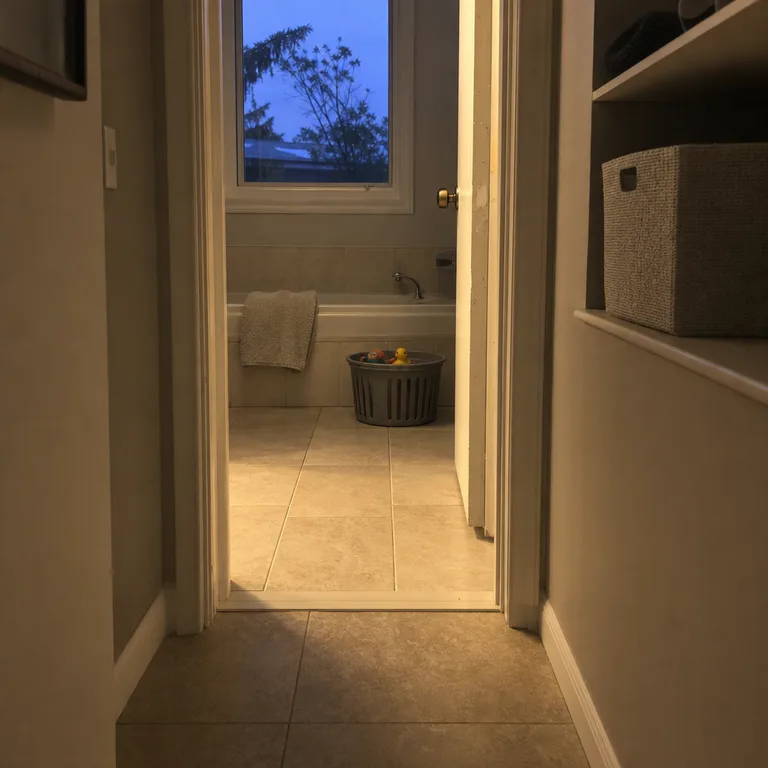 A small draining bin holds a limited set of bath toys in the bathroom while extra toys are stored separately in a closet bin.