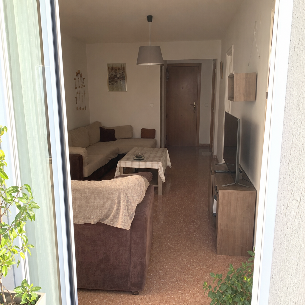 Small living room arranged with a clear path from the entry to the balcony door.